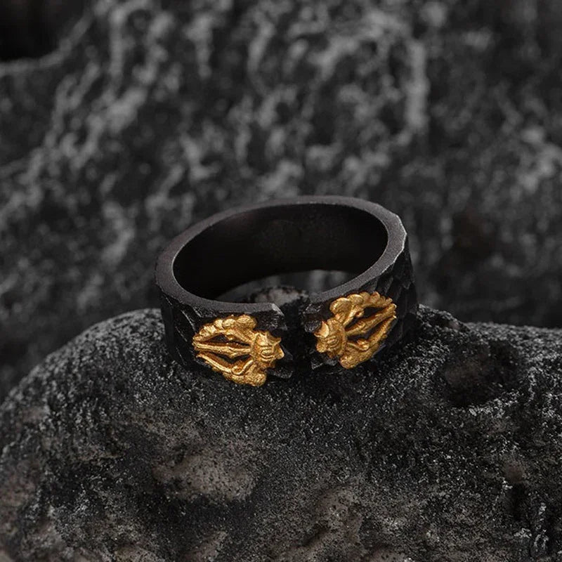 Black ring with gold dragon claws, rugged texture, bold statement jewelry for men